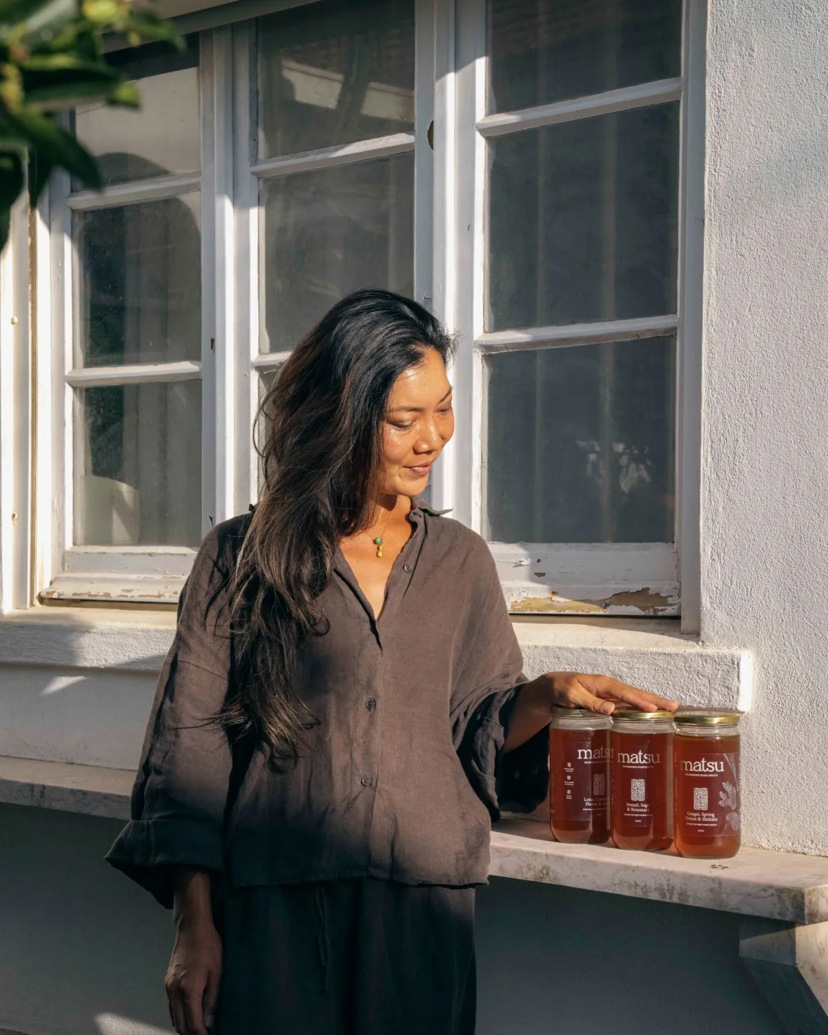 Karen, founder of Matsu, brewing bone broth in her Ericeira kitchen Karen, founder of Matsu, in her Ericeira kitchen beside a stockpot